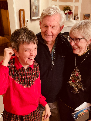 Amanda laughing and smiling with our parents, Susan and Patrick Broderick.